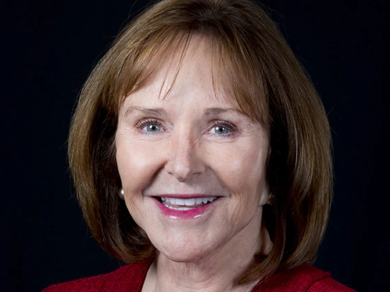 Jan smiling, wearing a red button up shirt