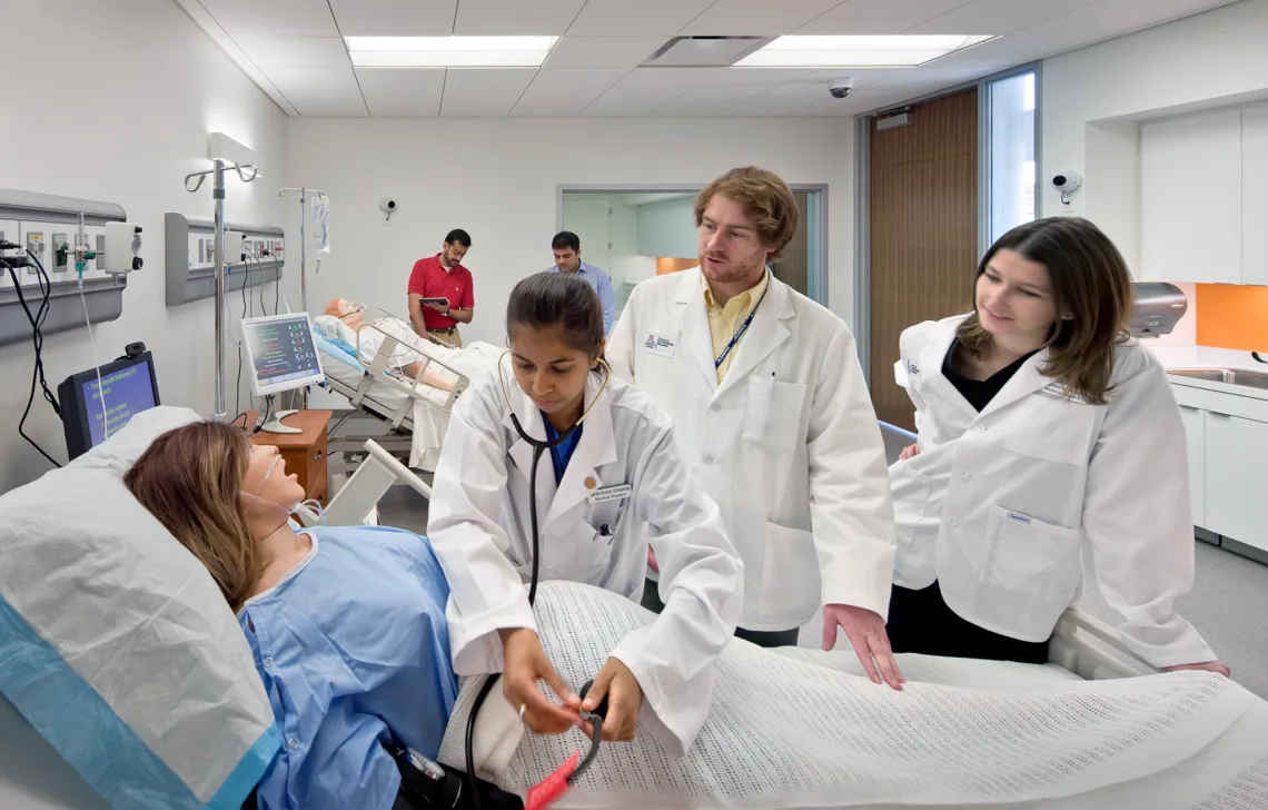 Image of three UArizona students learning and practicing.