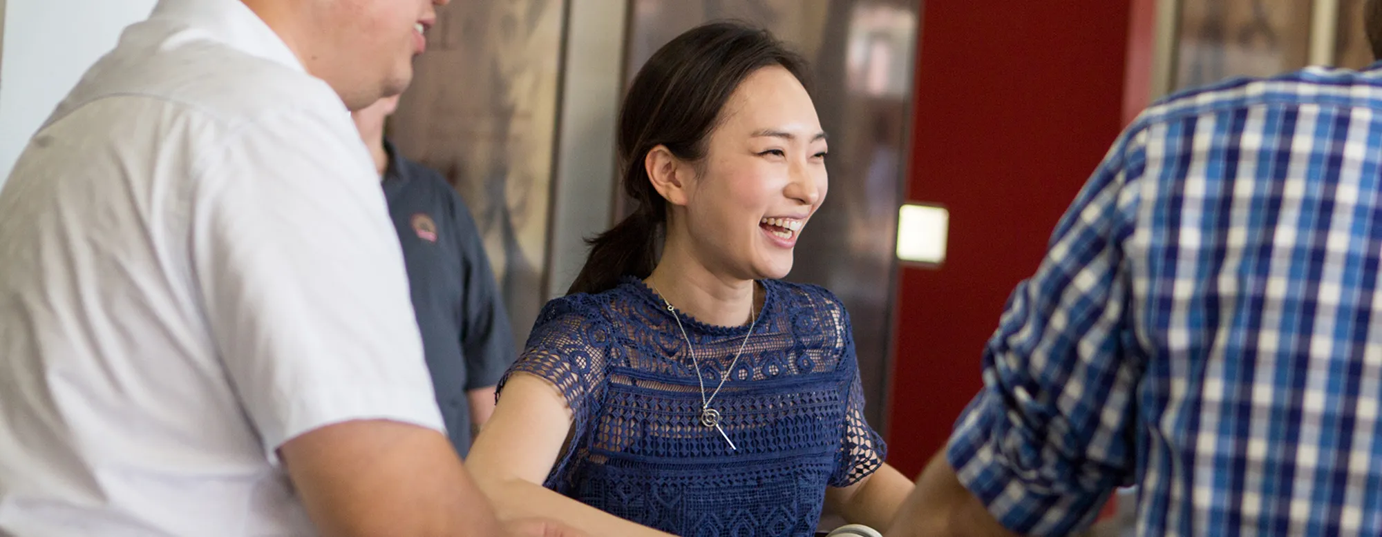 Woman laughing with peers