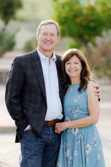 A photograph of Mike in a sports jacket and Sheri in a blue dress