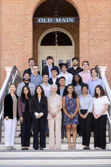 An image of Pat Gerleman standing on the steps of Old Main alongside many student recipients of her College of Medicine - Tucson student scholarship gift.