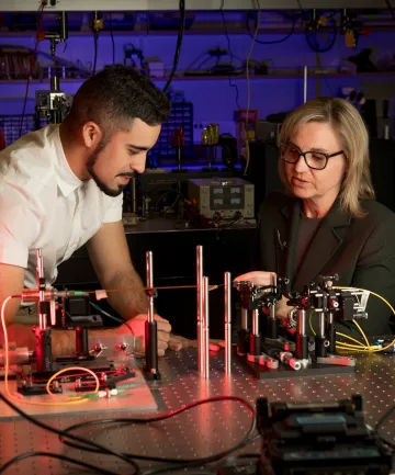 A photograph of Jennifer Barton and Ricky Cordova working together 